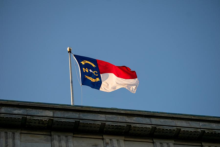 Photo of the North Carolina flag on the roof of a building